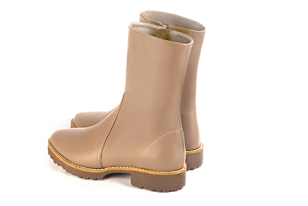 Tan beige women's ankle boots with a zip on the inside. Round toe. Flat rubber soles. Rear view - Florence KOOIJMAN
